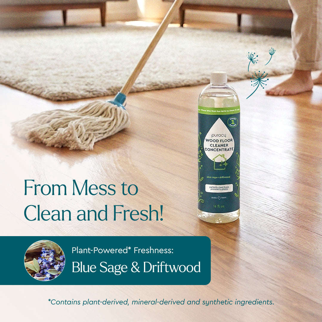 Puracy Everyday Multi-Surface Cleaner bottle and spray on a wooden floor surface, ready for cleaning and shining.