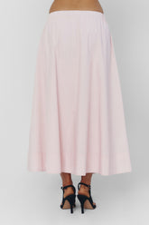 Findmenowthelabel UIARA pink skirt displayed on a hanger, showcasing its soft, baby pink fabric and stylish design.