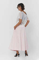 Findmenowthelabel UIARA pink skirt shown on a hanger, featuring a soft baby pink color and a flowy, stylish design.