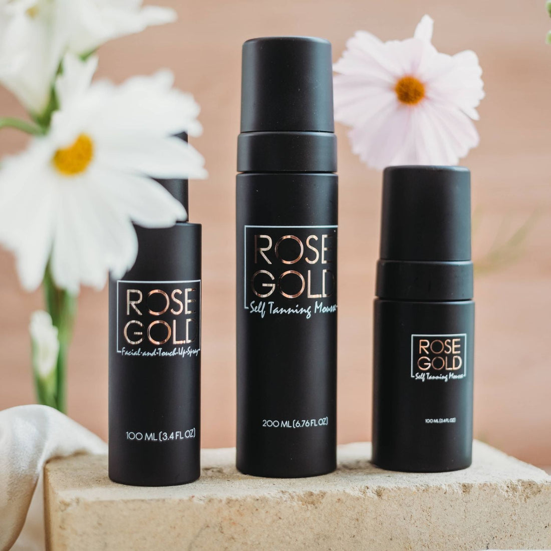 Rose Gold Sunless Face &amp; Body Self Tanning Bundle with various tanning products for a complete glow collection.