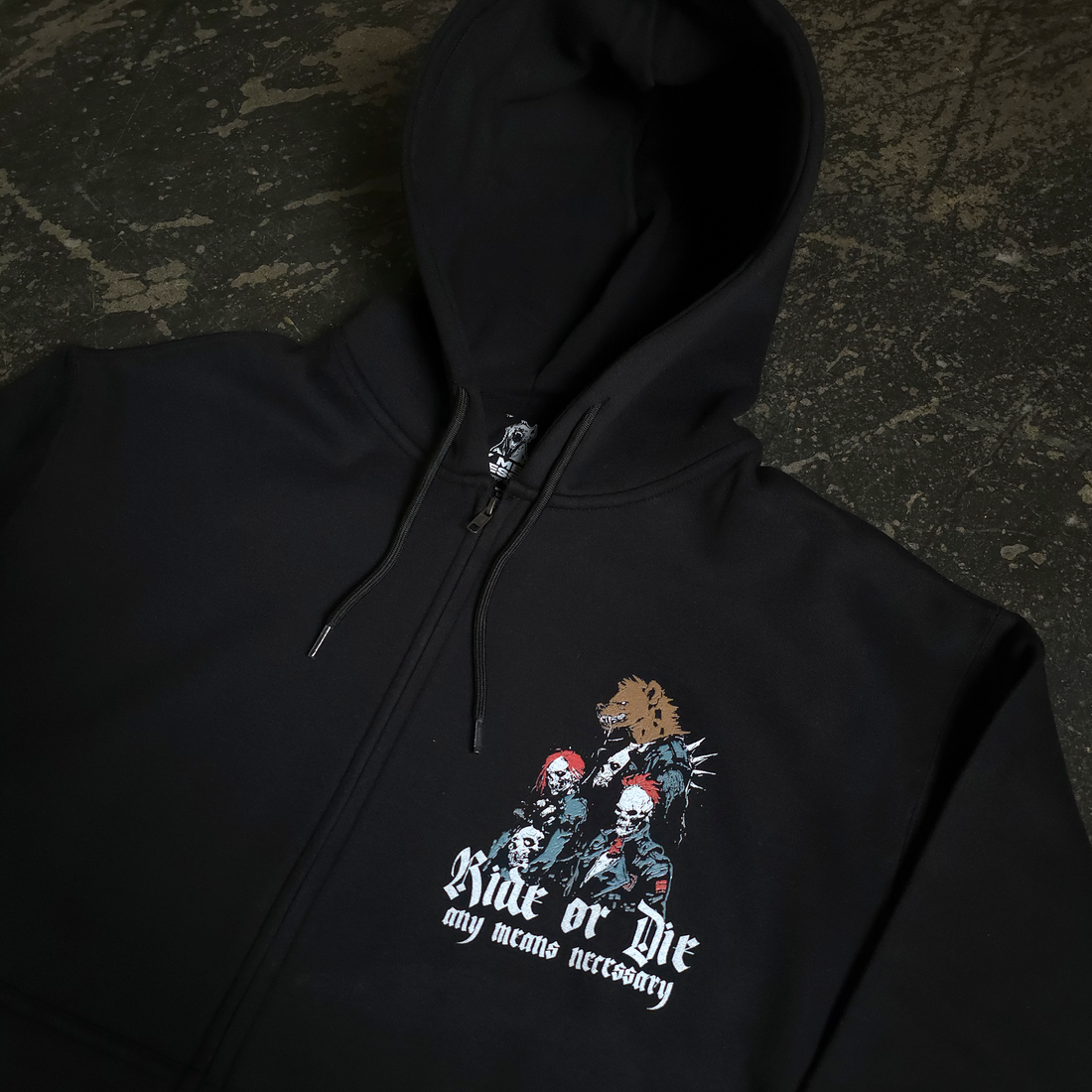 Black zip-up hoodie by Any Means Necessary Clothing featuring Ride or Die artwork on the front.