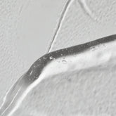 Swatch of Solawave Light Therapy Boosting Wand Activating Serum for skincare topicals, showing its smooth, clear gel texture.