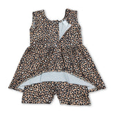 Young girl wearing sleeveless leopard print summer jumpsuit by Mini Rodeo, casual one-piece outfit for girls.