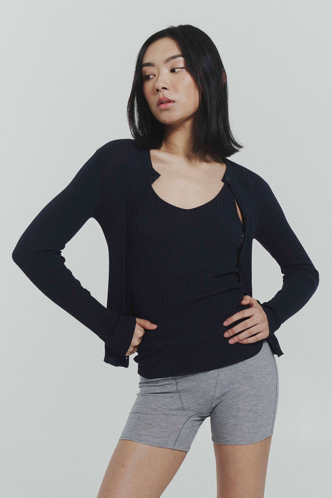 Navy ribbed knit cardigan by findmenowthelabel, featuring a cozy, fitted design with long sleeves and a front button closure.