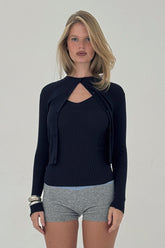 Navy ribbed knit cardigan from findmenowthelabel, featuring a fitted style with long sleeves and a button-up front.