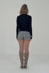 Navy ribbed knit cardigan from findmenowthelabel, featuring a cozy, textured knitwear design with a button-front closure.