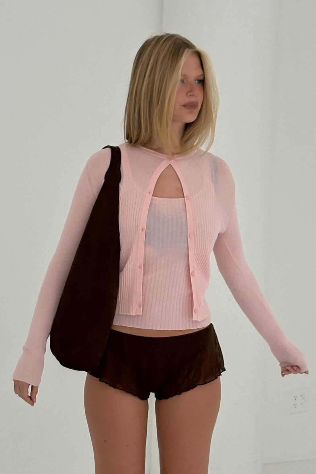 Pink ribbed knit cardigan from findmenowthelabel, featuring a cozy, textured knitwear design in powder pink.