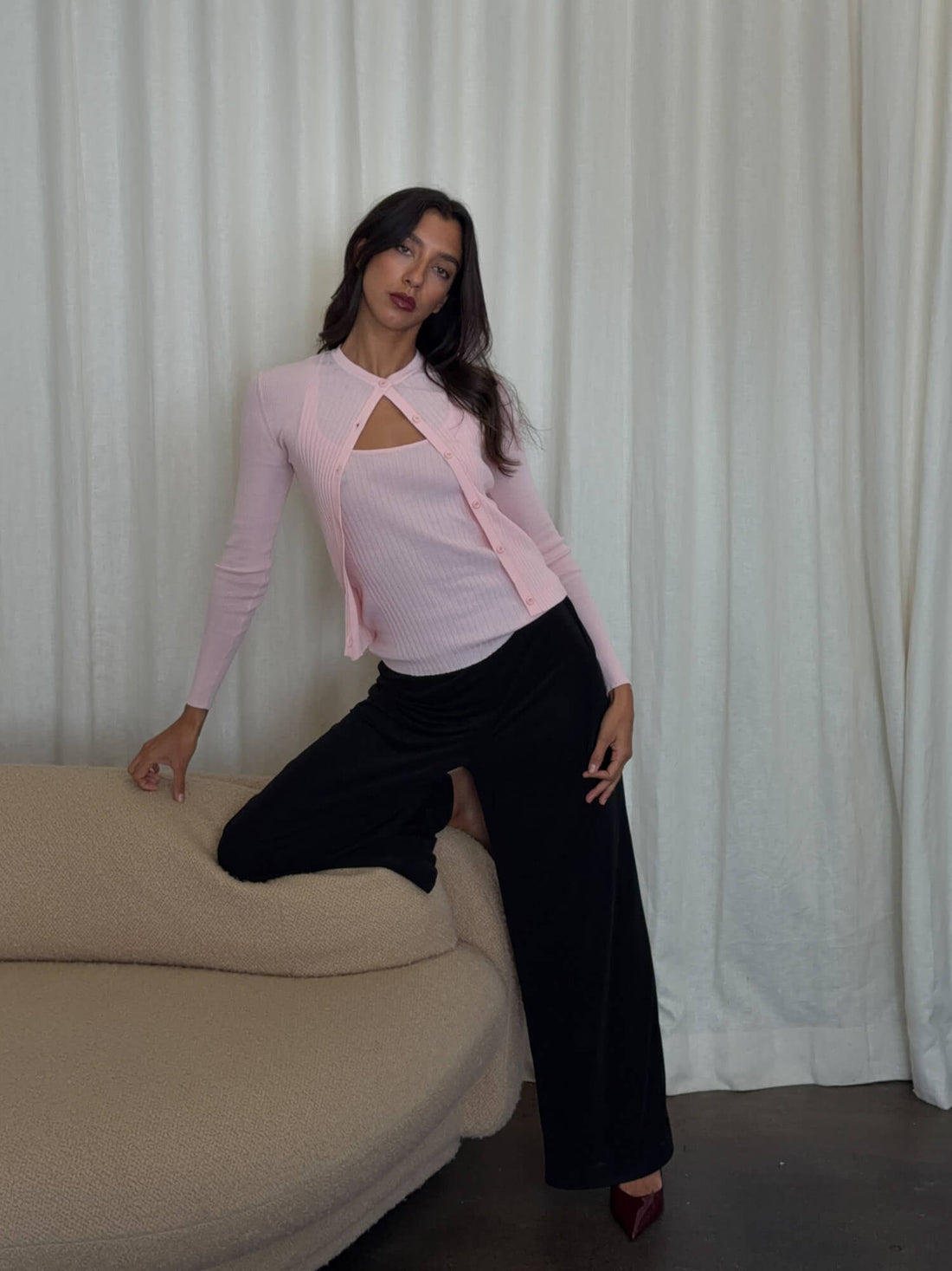 Powder pink ribbed knit cardigan from findmenowthelabel, featuring a cozy, fitted design with long sleeves and a button-up front.