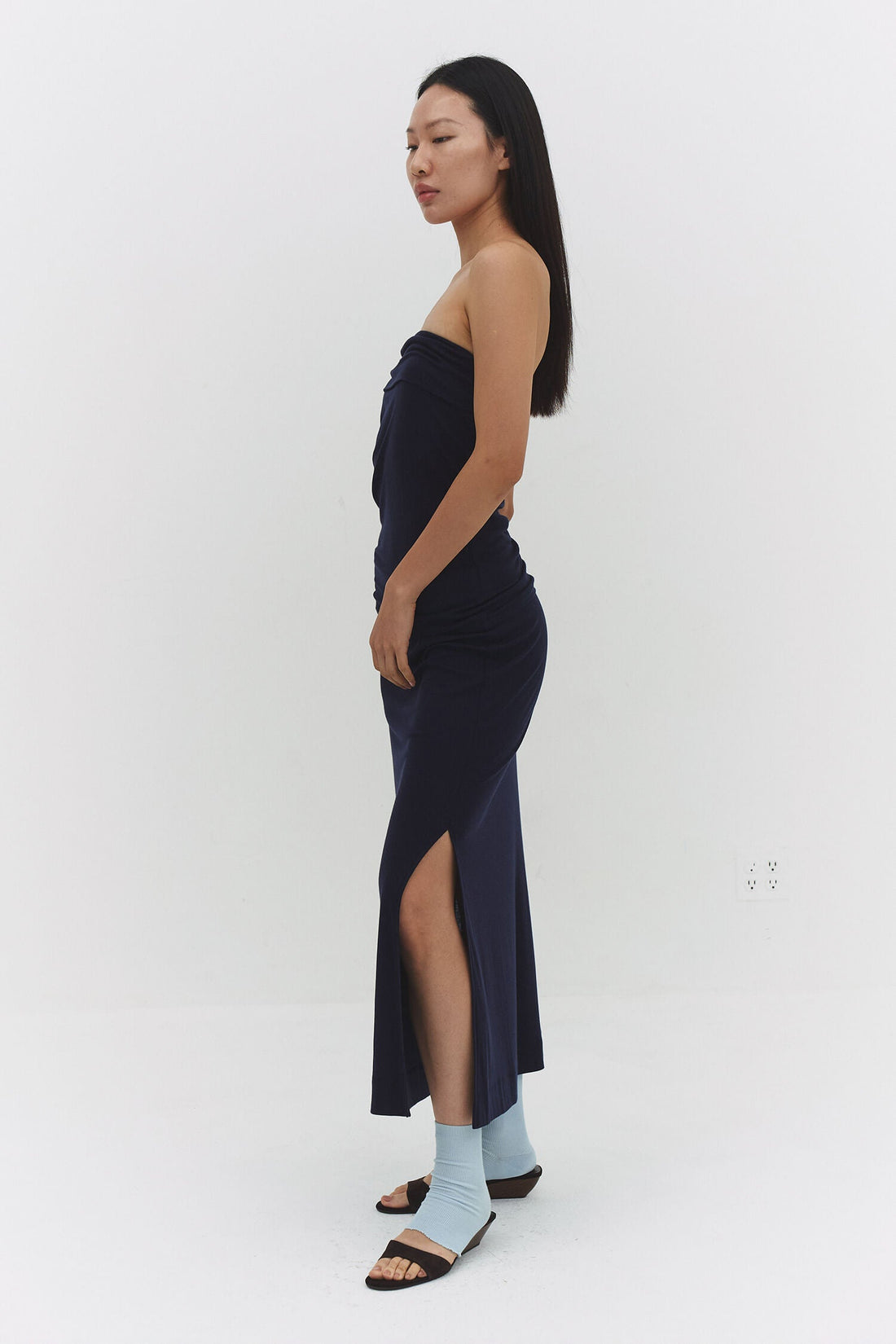 Findmenowthelabel navy skirt with a sleek, tailored design, shown in a close-up image highlighting fabric and stitching details.