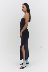 Findmenowthelabel navy skirt with a sleek, tailored design, shown in a close-up image highlighting fabric and stitching details.