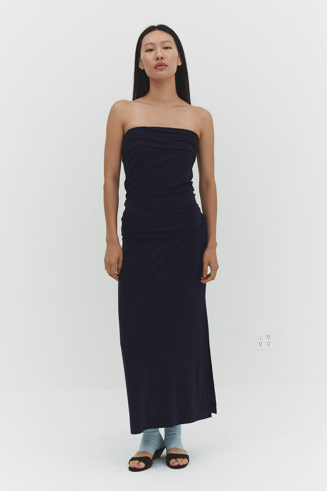 Navy SORI skirt by findmenowthelabel, featuring a stylish design and fabric details, displayed on a hanger against a neutral background.