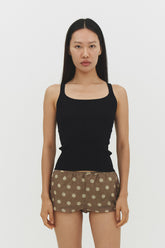 Black ribbed knit tank top by findmenowthelabel, close-up of fitted sleeveless knitwear with textured ribbing.