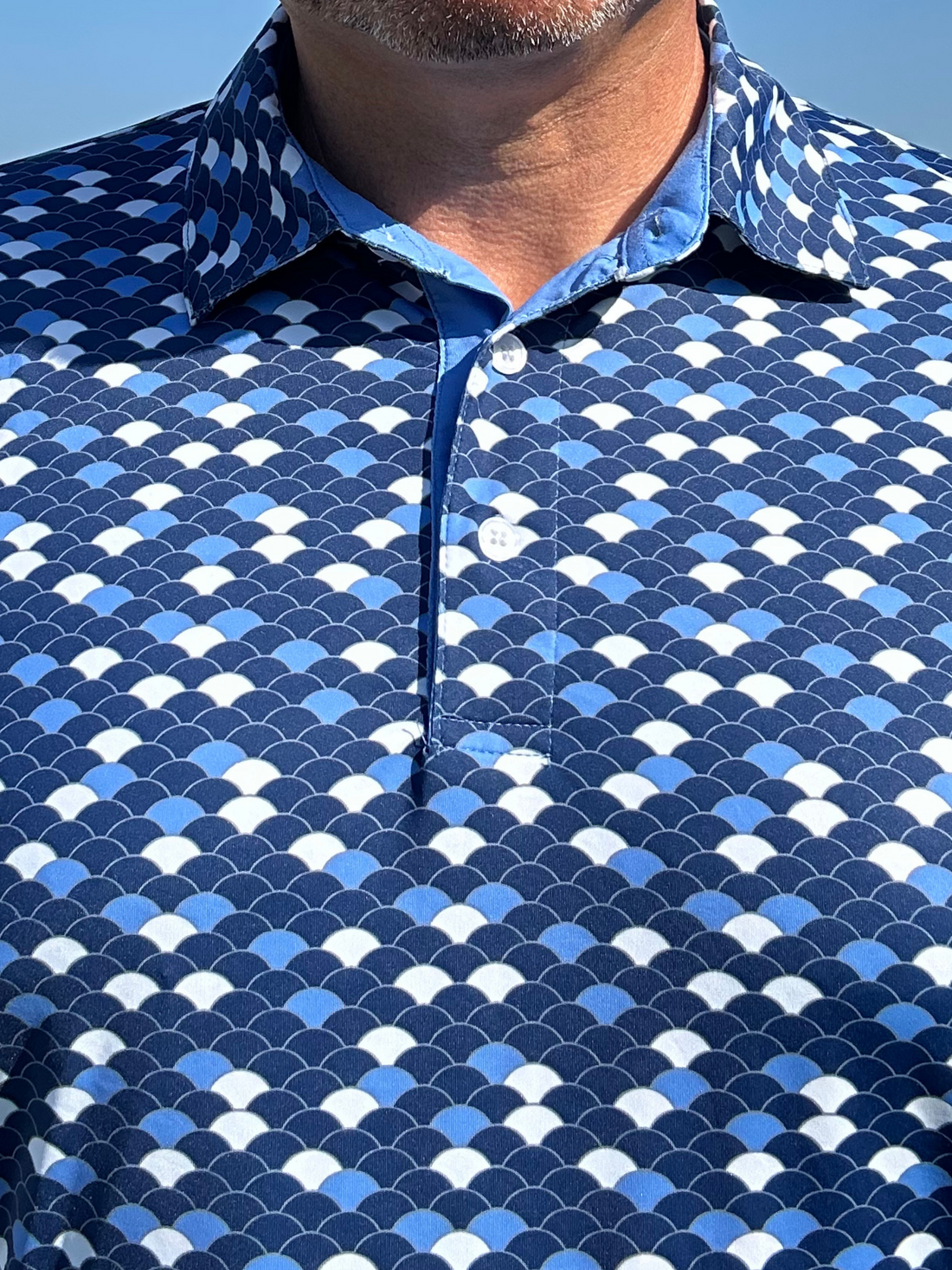 Close-up of White Water Life Scales Polo shirt fabric showing texture and stitching details.