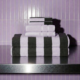 Luxury Capri Australian Cotton Bath Towels by Italic, shown in a soft, plush set with a neutral color, displayed folded on a bathroom shelf.