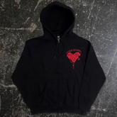 Black zip-up hoodie from Any Means Necessary Clothing with sharp edge design on the front.