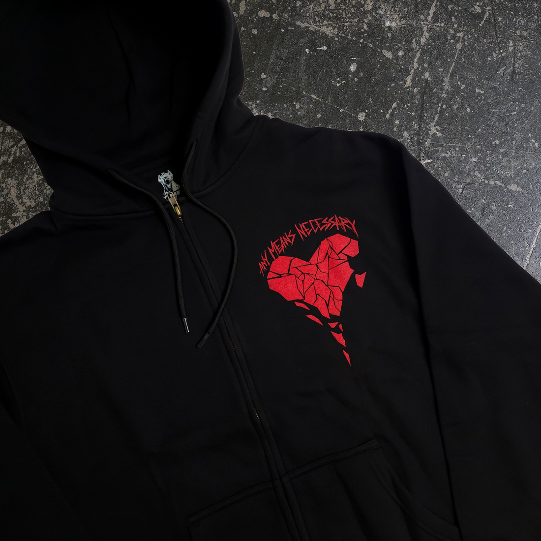 Black Sharp Edges zip-up hoodie by Any Means Necessary Clothing, front view showing the hoodie’s zip closure and sharp edge design.