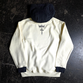 Cream-colored Sigil Pullover Hoodie by Any Means Necessary Clothing, showing the back design and relaxed fit.