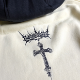Cream-colored Sigil Pullover Hoodie by Any Means Necessary Clothing, front view showing the sigil graphic design.