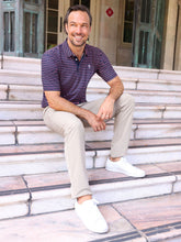 Navy striped White Water Life Striper Polo shirt displayed on a hanger, showcasing its casual, nautical-inspired design.