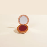 YENSA Super Serum Silk Buildable Cream Blush in Berry Passion, showing a smooth, vibrant pink blush on the skin.