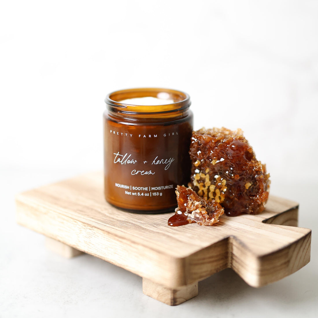 Fragrance-free tallow and honey cream for sensitive skin by Pretty Farm Girl, shown in a 5.4 oz jar with creamy texture.