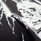 Close-up of Any Means Necessary Clothing Defeatist pullover hoodie showing the fabric texture and detailed design on the front.