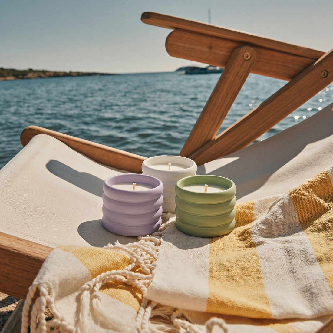Three soy wax ceramic candles by Italic, featuring minimalist designs and warm, inviting tones in a stylish arrangement.