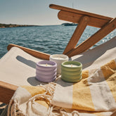 Three soy wax ceramic candles by Italic, featuring minimalist designs and warm, inviting tones in a stylish arrangement.