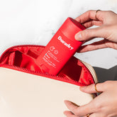 Duradry travel bag with multiple compartments and zipper closures, designed for convenient toiletry and personal item storage.