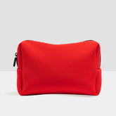 Duradry travel toiletry bag in red with multiple compartments for organizing toiletries and personal items.