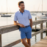 Light blue and navy Tuna Performance Polo by White Water Life, featuring a classic fit and breathable fabric, displayed on a hanger.