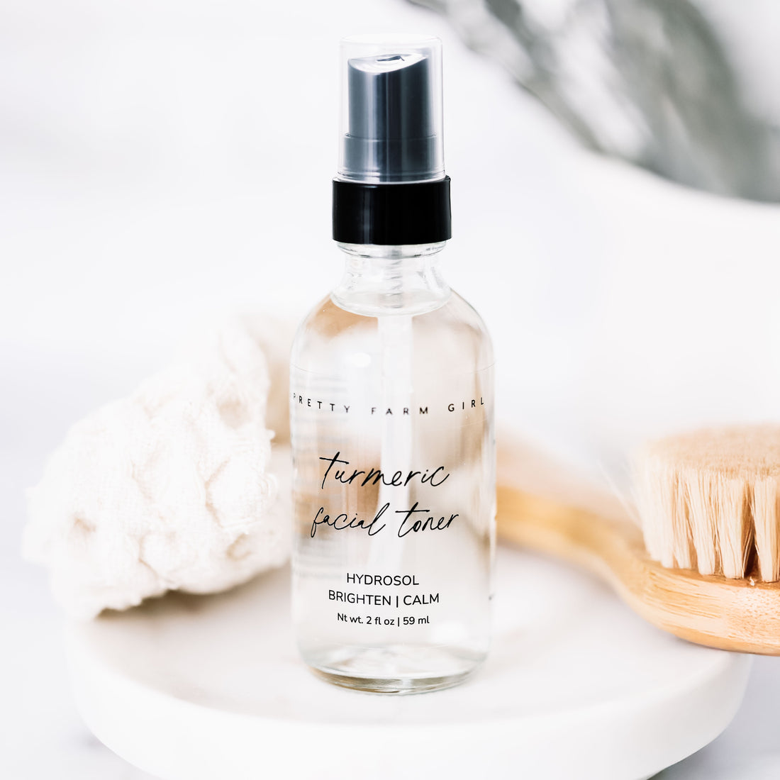 Organic turmeric facial toner by Pretty Farm Girl, featuring a bottle of turmeric-infused toner for evening skin tone correction.