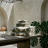 Italic Deia Australian Cotton Towels set shown with luxurious, plush texture in a stylish home bed setting.