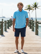 Navy Vacation Performance Polo by White Water Life displayed on a hanger against a plain background.