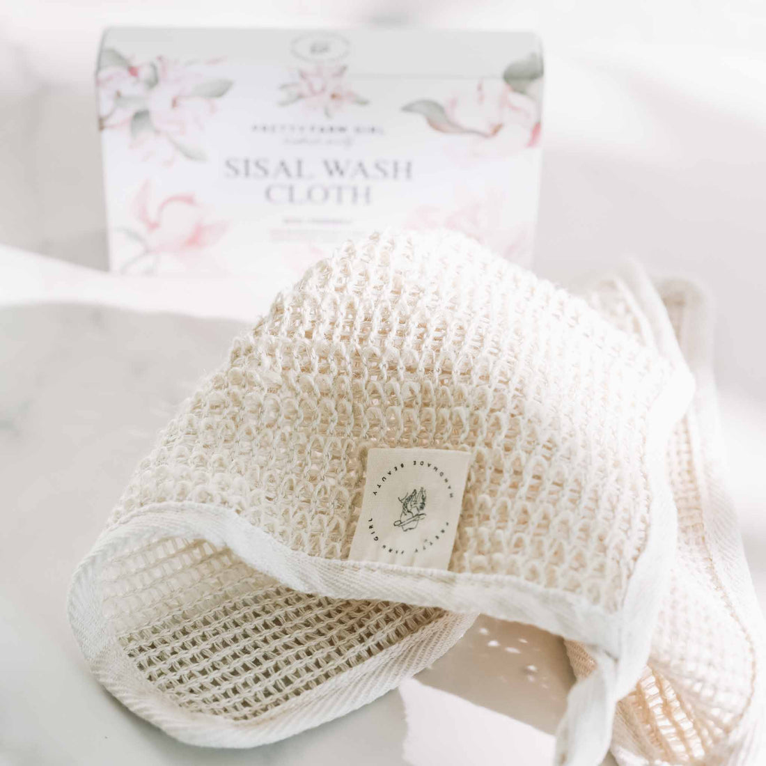 Natural sisal exfoliating wash cloth from Pretty Farm Girl, showing textured surface for gentle skin scrubbing.