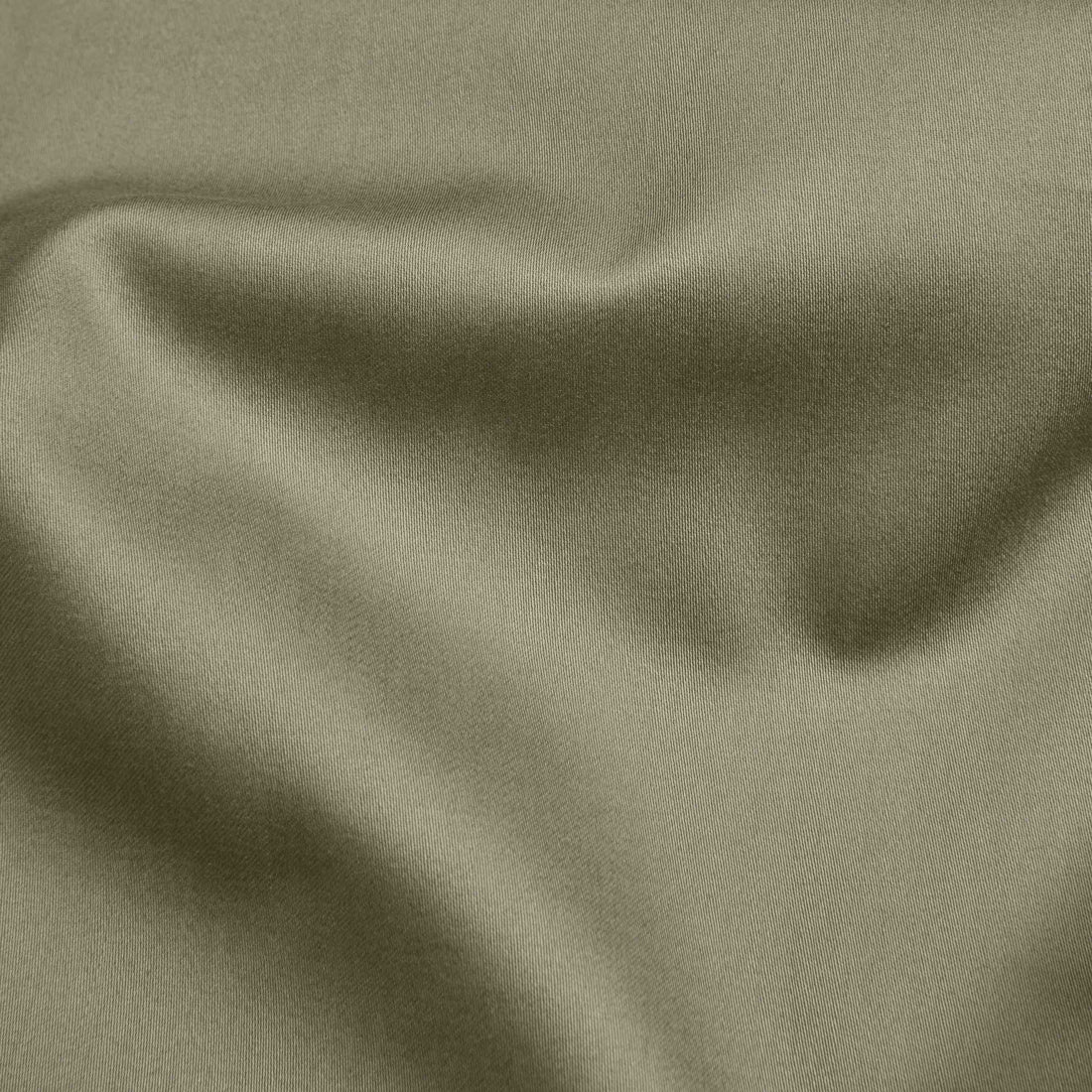 Luxe Australian Sateen Sheet Set by Italic with smooth, silky fabric in neutral tones, neatly folded on a bed.