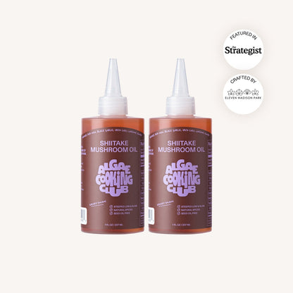 Shiitake mushroom infused oil in a glass bottle, produced by Algae Cooking Club, with fresh shiitake mushrooms and oil visible.