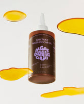 Bottle of mushroom-infused oil from Algae Cooking Club, showcasing clear glass container with dark mushroom-flavored oil.