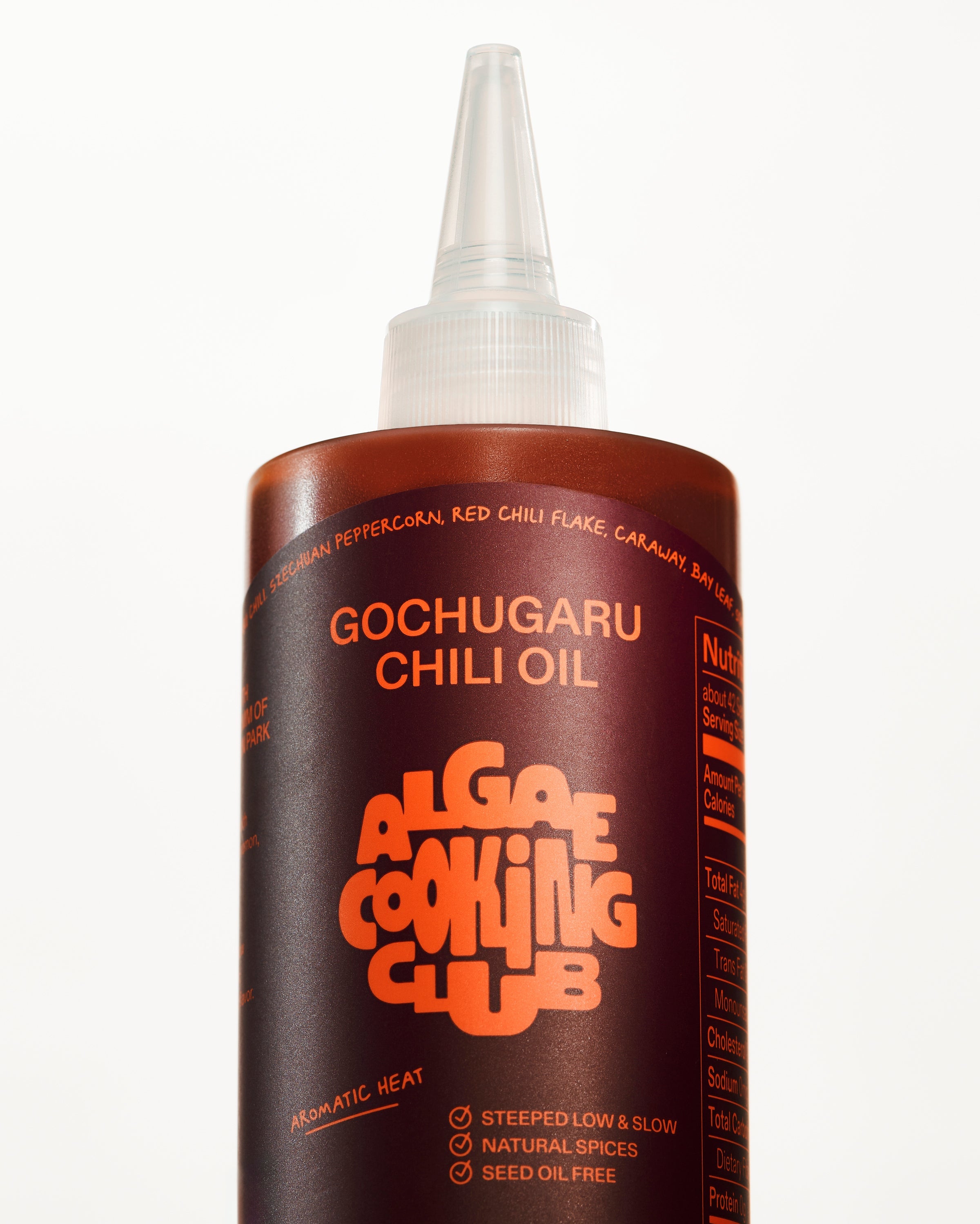 Algae Cooking Club Chef Squeeze Trio oil bottles with colorful labels, arranged on a wooden surface for culinary use.