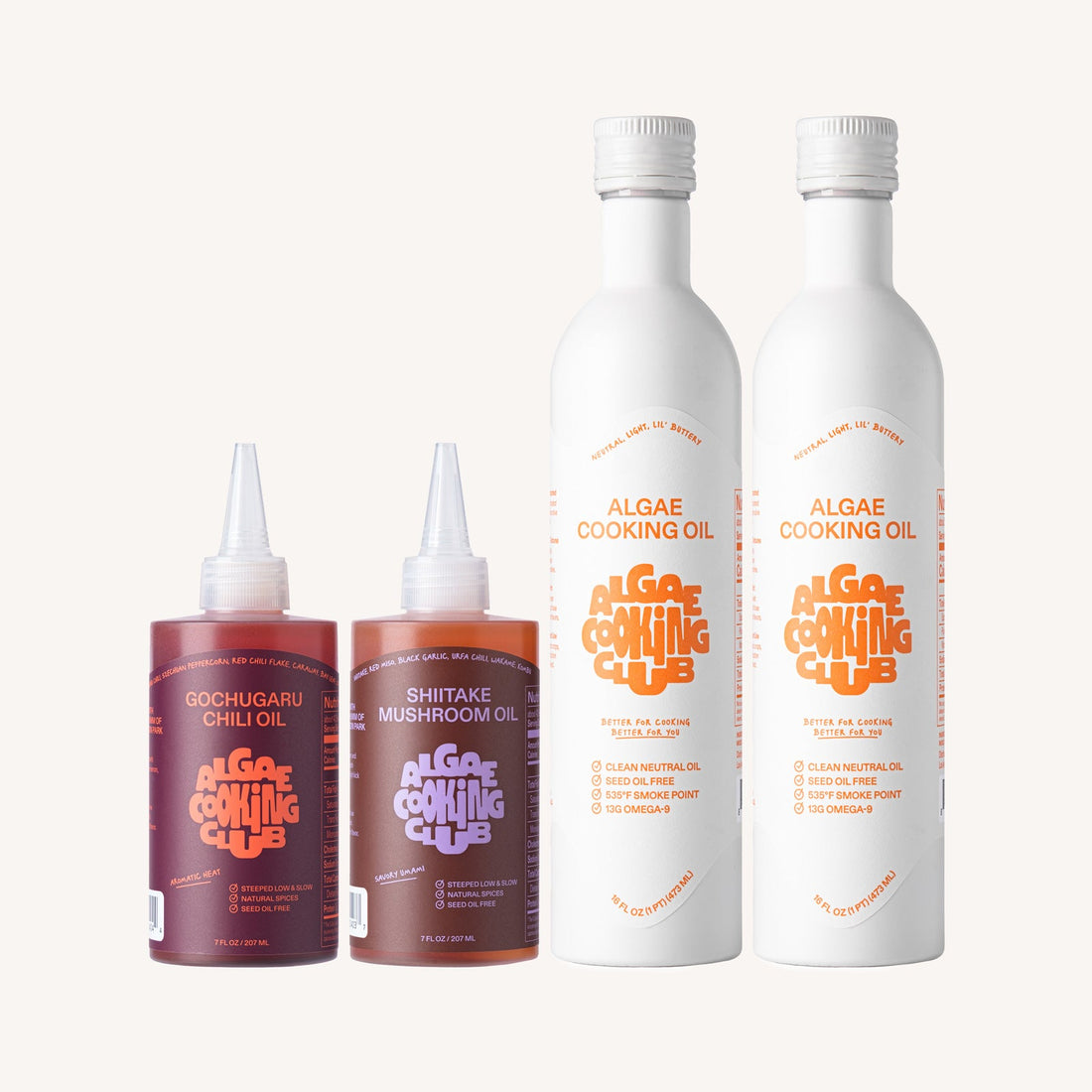 Algae Cooking Club The Club Bundle oil set featuring bottles of algae-infused cooking oils on a wooden surface.