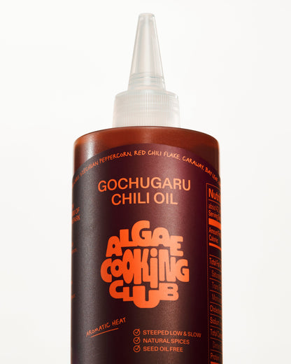Algae Cooking Club The Club Bundle oil bottle with label, featuring a sleek design and natural algae oil appearance.