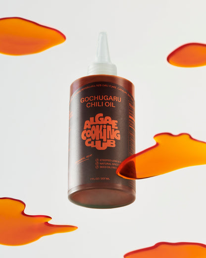 Algae Cooking Club The Heat Bundle oil bottle with label, featuring natural algae-based cooking oil on a kitchen countertop.