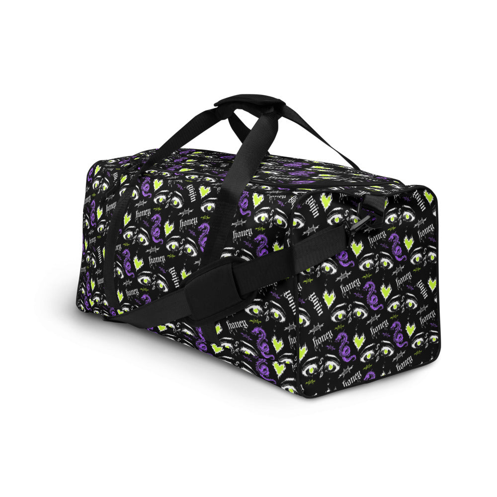 Yūjin Clothing Honey Duffle Bag with sturdy handles, spacious interior, and durable fabric with leather details for versatile travel use.