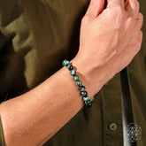 Seraphinite bracelet of transformation by Conscious Items featuring a rare angel energy charm and polished green stone beads.
