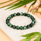 Seraphinite bracelet of transformation by Conscious Items featuring angel energy, showcasing a green, shimmering gemstone bracelet.