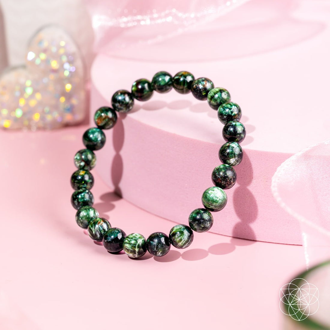 Seraphinite bracelet of transformation by Conscious Items featuring angel energy, showcasing polished green stones on a delicate bracelet.