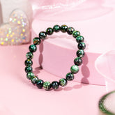 Seraphinite bracelet of transformation by Conscious Items featuring angel energy, showcasing polished green stones on a delicate bracelet.