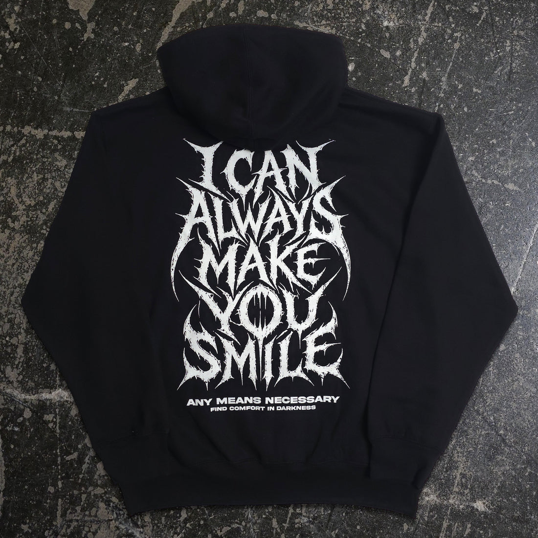 Back view of black Always Smile hoodie by Any Means Necessary Clothing, featuring a smiling face graphic on the back.