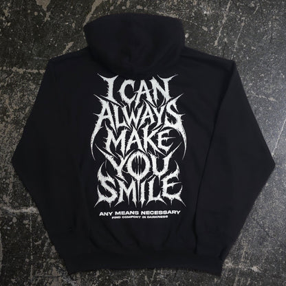 Back view of black Always Smile hoodie by Any Means Necessary Clothing, featuring a smiling face graphic on the back.