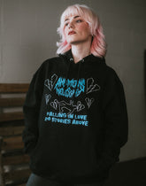 Black Falling in Love hoodie by Any Means Necessary Clothing, featuring a stylish pullover design and comfortable fit.